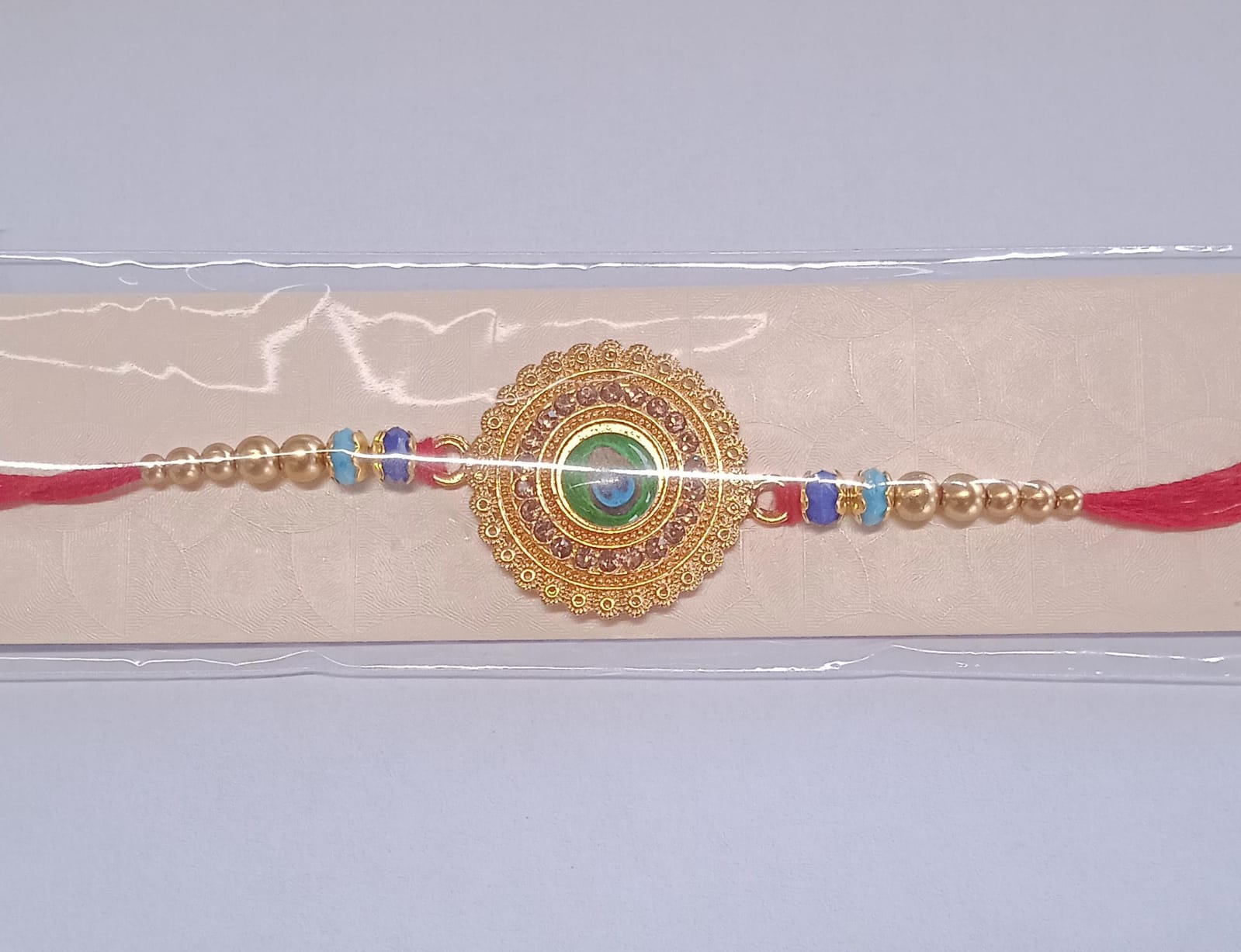 Peacock Feather Design Rakhi With Beaded Detailing